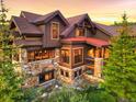 Attractive home with stone accents, expansive windows, and a beautiful outdoor deck at 59 Gold Run Rd, Breckenridge, CO 80424