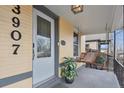 Inviting front porch featuring a hanging swing, perfect for enjoying a relaxing moment with a covered ceiling and pot of greenery at 3907 S Lincoln St, Englewood, CO 80113