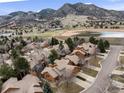 Stunning aerial view of the community with mountain backdrop and scenic lake at 16052 Deer Ridge Dr # B, Morrison, CO 80465
