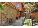Exterior view showcasing the architecture, landscaping, and gated entryway at 16052 Deer Ridge Dr # B, Morrison, CO 80465