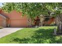 Charming home featuring an attached garage, well-maintained lawn, and mature landscaping at 16052 Deer Ridge Dr # B, Morrison, CO 80465