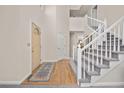 Inviting entryway with hardwood floors, a staircase, and neutral walls, creating a warm and welcoming atmosphere at 6868 Johnson St, Arvada, CO 80004