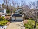 An elevated front exterior shot of a well-kept two-story home with a three-car garage at 6868 Johnson St, Arvada, CO 80004
