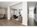 Bright, open-concept living room with hardwood floors and modern decor for comfortable living at 8110 S Kellerman Cir, Aurora, CO 80016