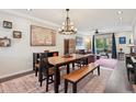 Open concept dining area with hardwood floors and decorative chandelier at 48 Galapago St, Denver, CO 80223