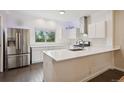 Bright kitchen with stainless steel appliances, white cabinetry, and quartz countertops at 48 Galapago St, Denver, CO 80223
