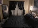Comfortable bedroom showcasing dark curtains and a cozy bed at 6711 S Ivy Way # B5, Centennial, CO 80112