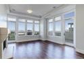 Spacious living room with hardwood floors, recessed lighting, and a cozy fireplace at 5455 Landmark Pl # 407, Greenwood Village, CO 80111