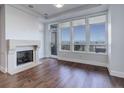 Bright living room features large windows, hardwood floors and a cozy fireplace at 5455 Landmark Pl # 407, Greenwood Village, CO 80111