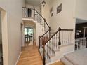 Bright foyer with hardwood floors and an elegant staircase with views to dining room at 7290 S Cook Cir, Centennial, CO 80122