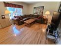 Cozy living room featuring hardwood floors, a large window, and comfortable furniture at 7290 S Cook Cir, Centennial, CO 80122