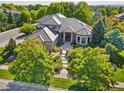 Beautiful home surrounded by lush trees with a stone tiled roof and meticulously landscaped front yard at 5350 S Marshall St, Littleton, CO 80123