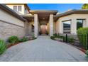 Inviting front entrance with a landscaped walkway, stone pillars, and a solid wood door, radiating curb appeal at 5350 S Marshall St, Littleton, CO 80123