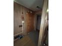 Home entryway featuring wood wall paneling and a paneled wood door at 7795 Raritan St, Denver, CO 80221