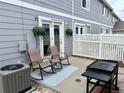 Cozy backyard patio with seating, barbecue, privacy fence, and outdoor lounging area at 5776 Biscay St, Denver, CO 80249