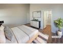 Staged main bedroom with ensuite bathroom and a modern dresser at 120 Sabin Way, Lochbuie, CO 80603