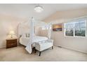 Light and airy bedroom featuring a canopy bed, bench and natural lighting at 24285 E Wagon Trail Ave, Aurora, CO 80016