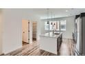 Bright kitchen with an island, stainless steel appliances, and open access to a walk-in pantry at 9645 Browns Peak Cir, Littleton, CO 80125