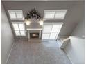 A bird's eye view of a sunlit living room featuring a fireplace, and neutral decor at 1847 S Union Blvd, Lakewood, CO 80228