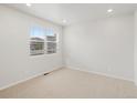 Bright, carpeted bedroom with neutral walls and a large window at 8809 Sedalia St, Commerce City, CO 80022