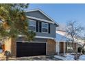 Two-story house with gray siding, brown brick, and a two-car garage at 11085 Utica Ct, Westminster, CO 80031