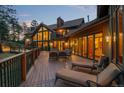 Relaxing deck with lounge chairs and access to the home's interior at 28940 Pinewood Vista Dr, Evergreen, CO 80439