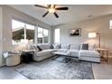 Bright living room featuring a large sectional sofa, neutral colors, and expansive windows at 4100 Albion St # 1509, Denver, CO 80216