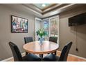 Cozy dining area features a round table, four chairs, and a bright window at 1503 W Briarwood Ave, Littleton, CO 80120