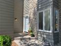 Inviting entryway with a stone wall, bay window, and a stylish front door at 1503 W Briarwood Ave, Littleton, CO 80120