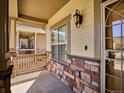 Charming front porch with stone accents and updated lighting fixtures, creating a warm and inviting entrance at 19368 E Quincy Pl, Aurora, CO 80015