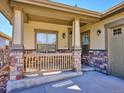 Inviting front porch with stone accents, providing a cozy and welcoming entrance to the home at 19368 E Quincy Pl, Aurora, CO 80015