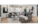 Bright living room featuring a comfortable sectional sofa, modern decor, and ample natural light from multiple windows at 2314 S University Blvd, Denver, CO 80210