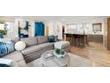 Open-concept living space with a large sectional sofa, breakfast bar, and modern decor for seamless entertaining at 2314 S University Blvd, Denver, CO 80210