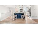 Open concept kitchen with a navy island and breakfast bar seating at 1070 W Oxford Ave, Englewood, CO 80110