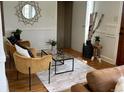 Cozy living room with stylish decor, including a glass coffee table, accent chairs, and hardwood flooring at 2088 Kearney St, Denver, CO 80207