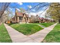 Scenic street view showcasing the home's location in a well-kept neighborhood with mature trees at 2088 Kearney St, Denver, CO 80207