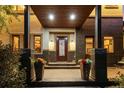Elegant home entrance with a covered porch, stylish lighting, decorative planters, and a modern front door at 1344 S Saint Paul St, Denver, CO 80210