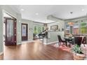 Inviting living space with hardwood floors, a piano, and elegant decor blending seamlessly with the dining area at 1344 S Saint Paul St, Denver, CO 80210