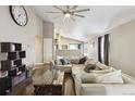 Bright living room boasts hardwood floors, neutral walls, and comfortable sectional seating at 3469 Amber Sun Cir, Castle Rock, CO 80108