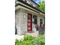 Close-up of the front door with stone surround, red door, stylish exterior lighting, and address numbers at 2805 S Sherman St, Englewood, CO 80113