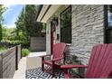 Inviting front porch with red chairs and stone facade at 2805 S Sherman St, Englewood, CO 80113