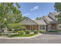 Inviting home with a well-manicured lawn, mature trees, and a charming front porch, enhancing its curb appeal at 6792 E Briarwood Dr, Centennial, CO 80112