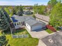 Aerial view of home with a well-maintained lawn, gray roof, and attached two-car garage at 7870 Sunflower Green # 151, Frederick, CO 80530