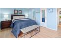 Bright bedroom featuring a comfortable bed, stylish bench and tasteful decor at 4801 E 9Th Ave # 209S, Denver, CO 80220