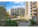 Exterior view of apartment building with manicured lawns, landscaping, and walking paths at 4801 E 9Th Ave # 209S, Denver, CO 80220