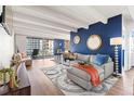Bright living room features modern decor, hardwood floors, a balcony and abundant natural light at 4801 E 9Th Ave # 209S, Denver, CO 80220