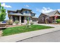 Stunning two-story home with a well manicured lawn and a large two-car attached garage at 22527 E Layton Cir, Aurora, CO 80015