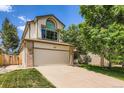 Two-story house with large arched window over the garage and large driveway at 5133 E Essex Ave, Castle Rock, CO 80104