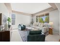 Bright living room featuring large windows, neutral colors, and comfortable seating creating an inviting space at 708 Teal Cir, Longmont, CO 80503