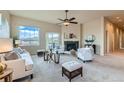 Bright living room with neutral decor, a fireplace, large windows, and a sliding glass door to the outdoor space at 6216 E 135Th Ave, Thornton, CO 80602